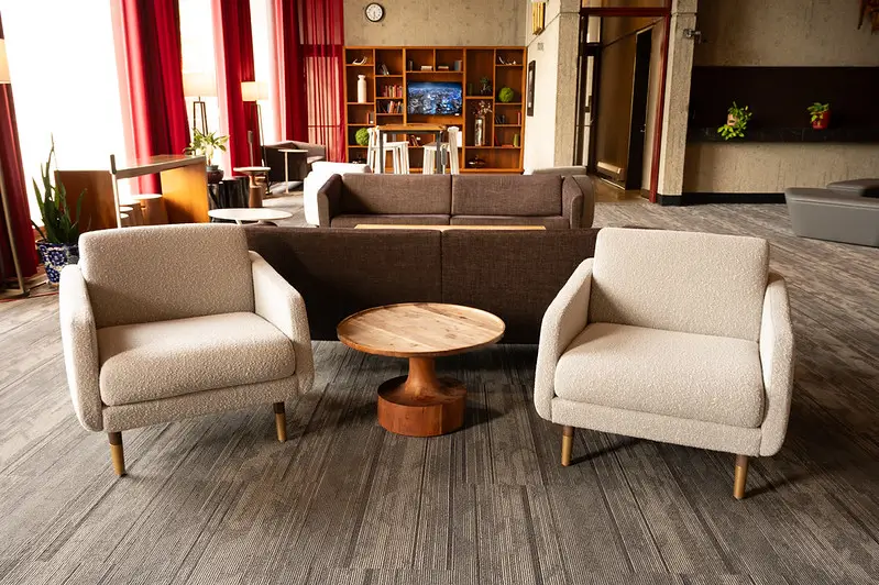 Hotel UMass lobby seating area with armchairs and sofa